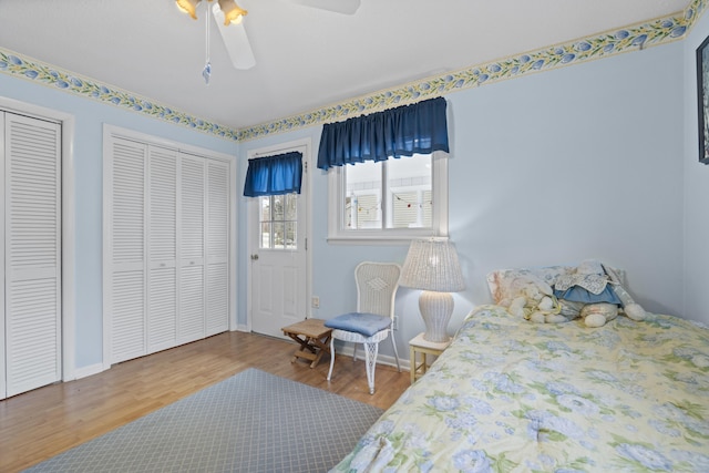 33 Cottage Ln, East Lyme, CT 06357 - bedroom with two closets, baseboards, ceiling fan, and wood finished floors