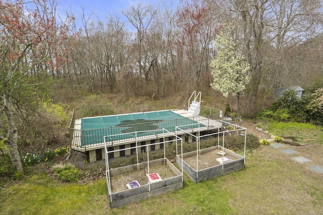 33 Cottage Ln, East Lyme, CT 06357 - view of swimming pool featuring a yard, a fenced in pool, a wooden deck, and a garden