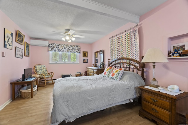 33 Cottage Ln, East Lyme, CT 06357 - bedroom with ceiling fan, a wall mounted AC, and wood finished floors