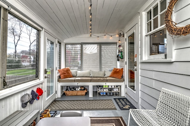 sunroom with rail lighting, lofted ceiling, wooden ceiling, and outdoor lounge area