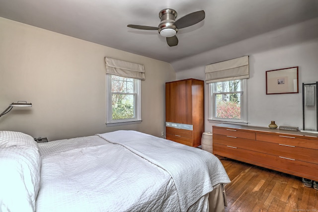 bedroom with wood-type flooring, a ceiling fan, and vaulted ceiling
