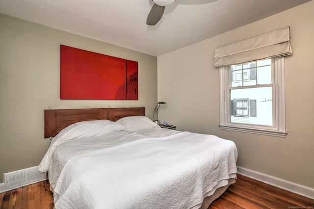 bedroom with baseboards, wood finished floors, and a ceiling fan