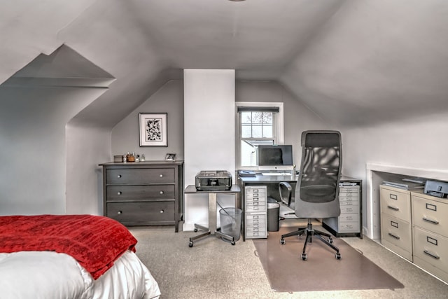 carpeted bedroom featuring lofted ceiling and an office area