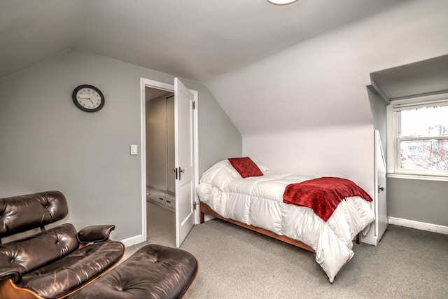 bedroom featuring vaulted ceiling, carpet flooring, and baseboards