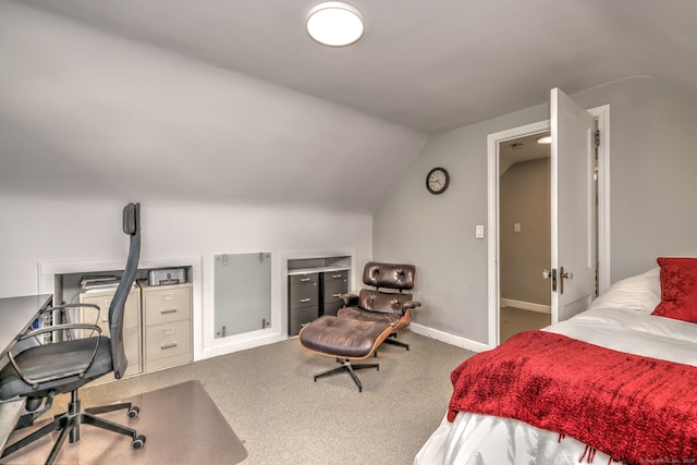 bedroom with vaulted ceiling, carpet floors, baseboards, and an office area