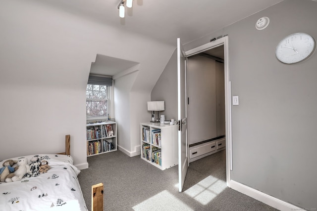 carpeted bedroom featuring baseboards and a baseboard heating unit