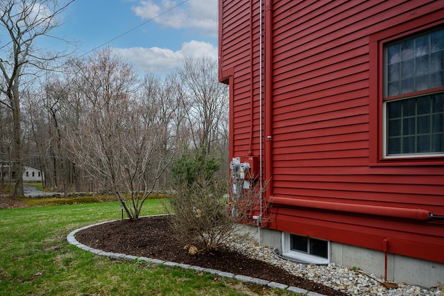 view of side of home with a lawn
