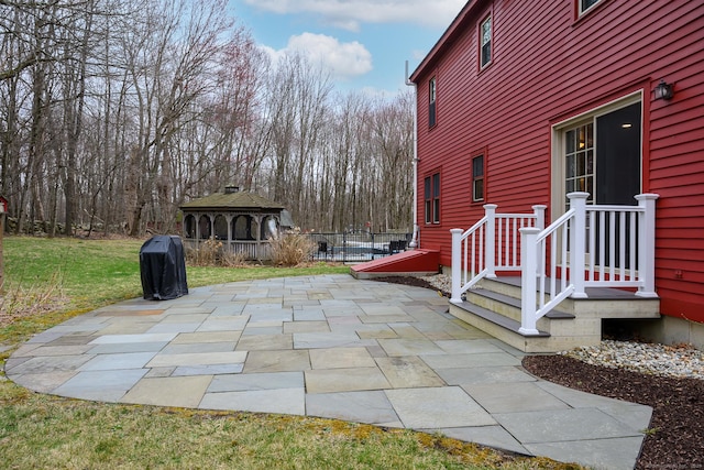 view of patio / terrace with fence and a gazebo