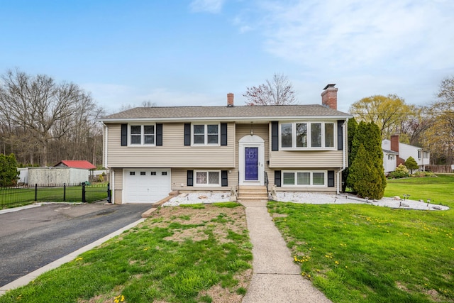 120 Newton St, Berlin, CT 06037 - bi-level home with a chimney, fence, an attached garage, a front yard, and aphalt driveway