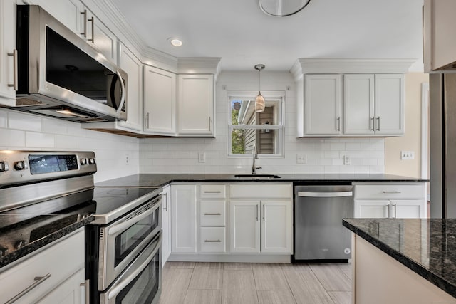 120 Newton St, Berlin, CT 06037 - kitchen featuring dark stone counters, tasteful backsplash, a sink, white cabinets, and appliances with stainless steel finishes
