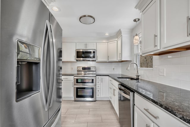 120 Newton St, Berlin, CT 06037 - kitchen with dark stone counters, a sink, white cabinets, stainless steel appliances, and backsplash