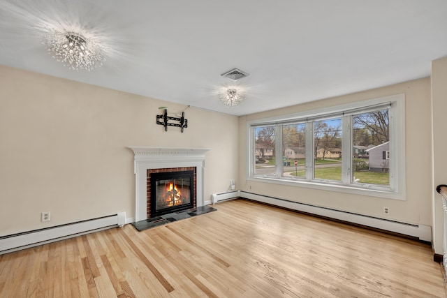 120 Newton St, Berlin, CT 06037 - unfurnished living room with a baseboard radiator, a brick fireplace, visible vents, and light wood-type flooring