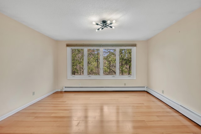 120 Newton St, Berlin, CT 06037 - empty room with a baseboard heating unit, wood finished floors, and a textured ceiling