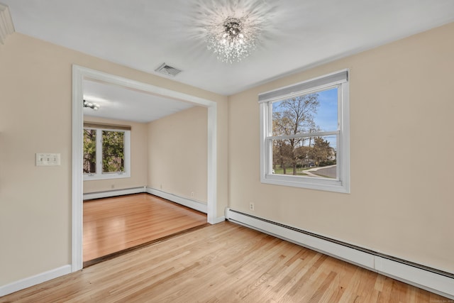 120 Newton St, Berlin, CT 06037 - spare room featuring a baseboard heating unit, wood finished floors, and a chandelier