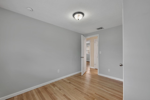 120 Newton St, Berlin, CT 06037 - spare room with a smoke detector, light wood-style flooring, and a textured ceiling