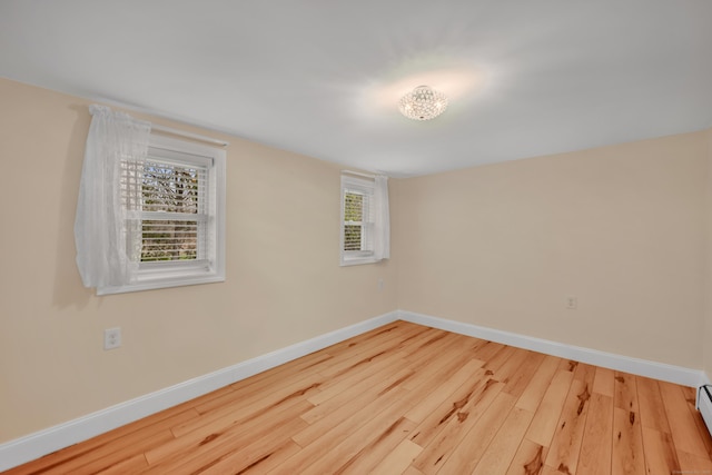 120 Newton St, Berlin, CT 06037 - empty room with a baseboard radiator, baseboards, wood finished floors, and plenty of natural light