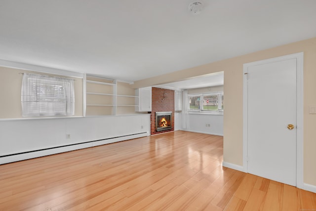 120 Newton St, Berlin, CT 06037 - unfurnished living room featuring baseboards, baseboard heating, wood finished floors, and a brick fireplace