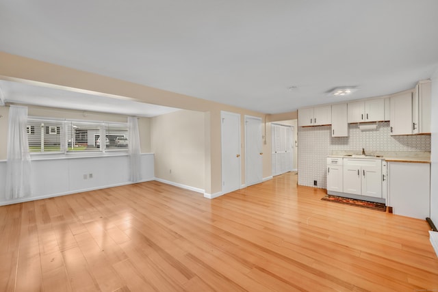 120 Newton St, Berlin, CT 06037 - kitchen with a sink, open floor plan, light wood-style flooring, light countertops, and white cabinets