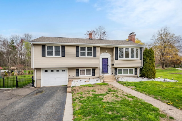 120 Newton St, Berlin, CT 06037 - split foyer home featuring a chimney, fence, driveway, a front yard, and a garage
