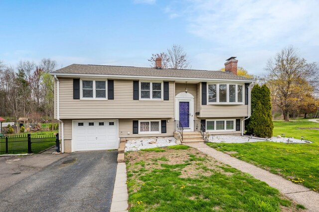 120 Newton St, Berlin, CT 06037 - raised ranch featuring a chimney, driveway, and an attached garage