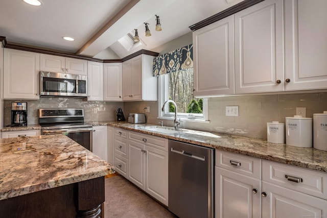 kitchen with white cabinets, stainless steel appliances, and a sink