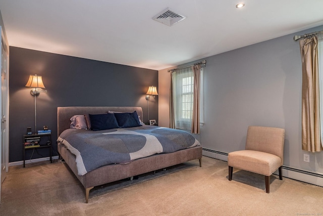 bedroom featuring visible vents, baseboards, baseboard heating, and light carpet