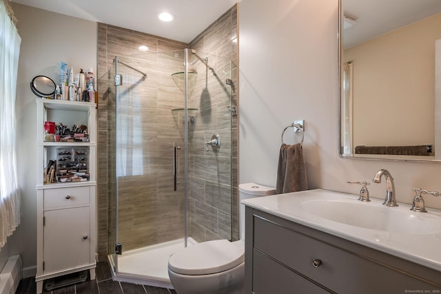 bathroom with vanity, recessed lighting, a stall shower, and toilet