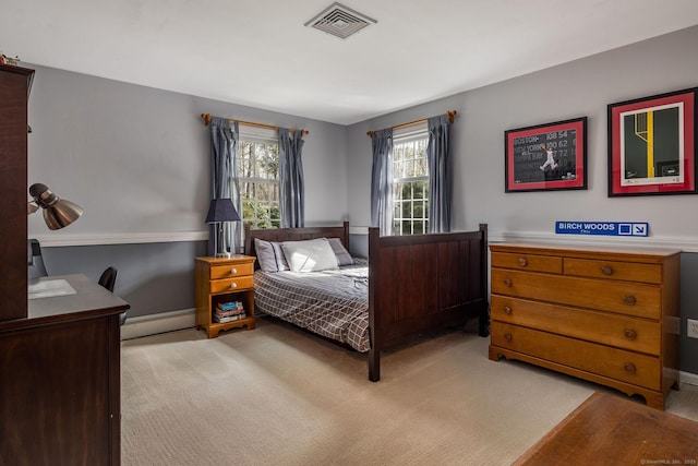 bedroom with visible vents, baseboards, baseboard heating, and light colored carpet