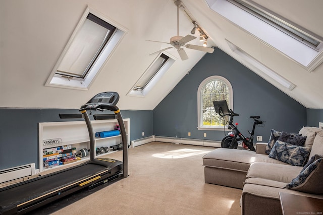workout room with ceiling fan, baseboard heating, rail lighting, carpet, and lofted ceiling with skylight