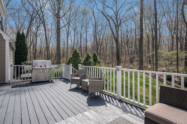 wooden terrace featuring area for grilling and a lawn