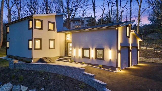 35 Bayberry Ln, Guilford, CT 06437 - back of property with a garage and stucco siding