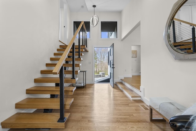 35 Bayberry Ln, Guilford, CT 06437 - foyer entrance with light wood finished floors, baseboards, a towering ceiling, and stairway