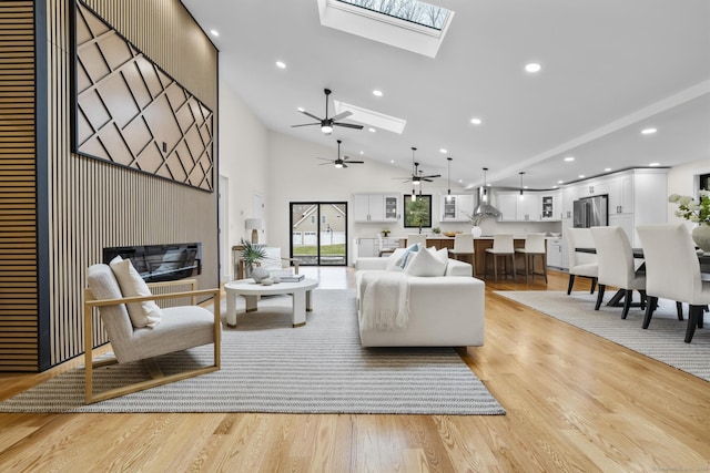 35 Bayberry Ln, Guilford, CT 06437 - living room featuring high vaulted ceiling, a ceiling fan, a skylight, light wood-style flooring, and recessed lighting
