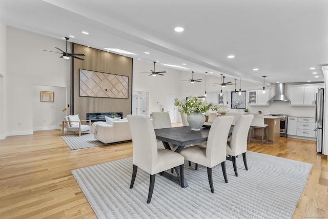 35 Bayberry Ln, Guilford, CT 06437 - dining space with a ceiling fan, a large fireplace, light wood-type flooring, and recessed lighting