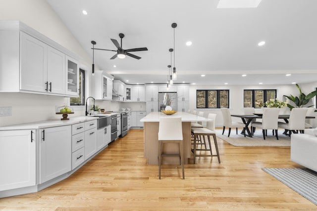 35 Bayberry Ln, Guilford, CT 06437 - kitchen with recessed lighting, a ceiling fan, stainless steel fridge with ice dispenser, light countertops, and a breakfast bar area