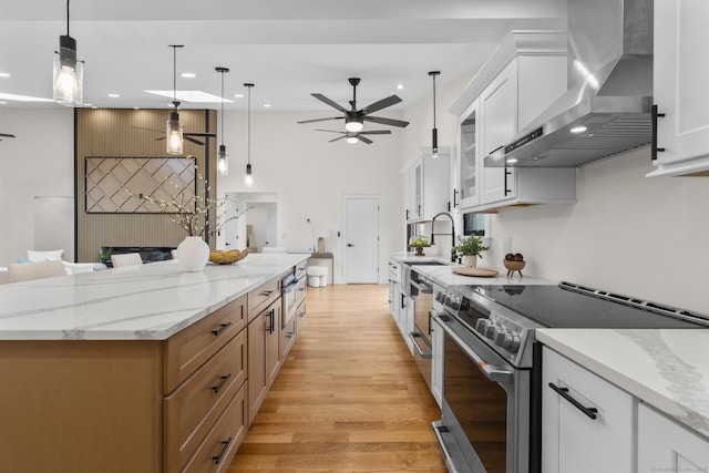 35 Bayberry Ln, Guilford, CT 06437 - kitchen with recessed lighting, stainless steel range with electric cooktop, light wood finished floors, wall chimney range hood, and a ceiling fan