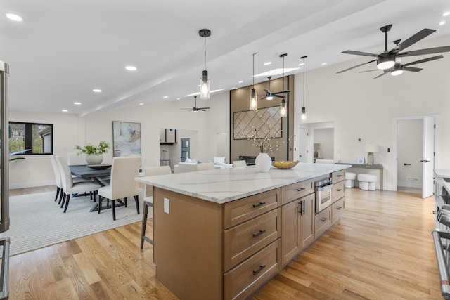 35 Bayberry Ln, Guilford, CT 06437 - kitchen with open floor plan, a kitchen breakfast bar, light wood-style flooring, high vaulted ceiling, and ceiling fan