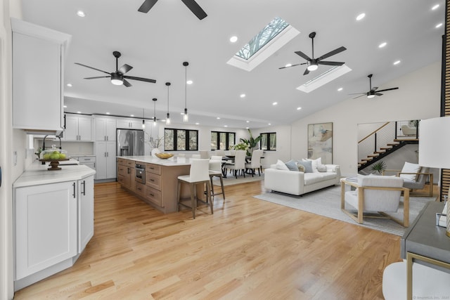 35 Bayberry Ln, Guilford, CT 06437 - living room featuring recessed lighting, light wood-style flooring, a skylight, and ceiling fan