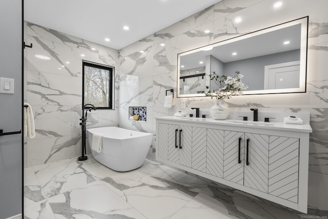 35 Bayberry Ln, Guilford, CT 06437 - full bath featuring a sink, double vanity, a freestanding bath, tile walls, and marble finish floor