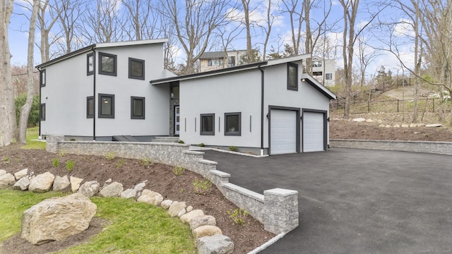 35 Bayberry Ln, Guilford, CT 06437 - view of front of house featuring stucco siding and a garage