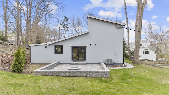 35 Bayberry Ln, Guilford, CT 06437 - rear view of property with central air condition unit, a yard, a patio, and stucco siding
