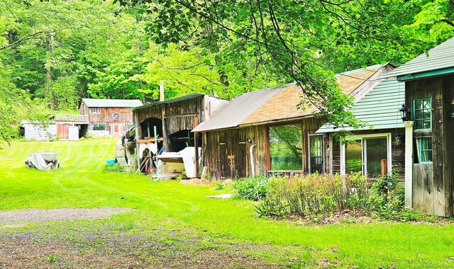 12 Wells Rd, New Milford, CT 06776 - view of green lawn with an outdoor structure and a forest view