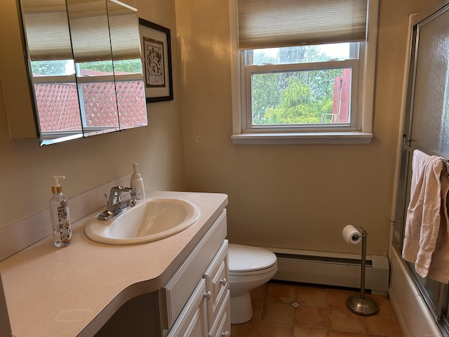 full bathroom featuring vanity, tile patterned flooring, toilet, enclosed tub / shower combo, and a baseboard heating unit
