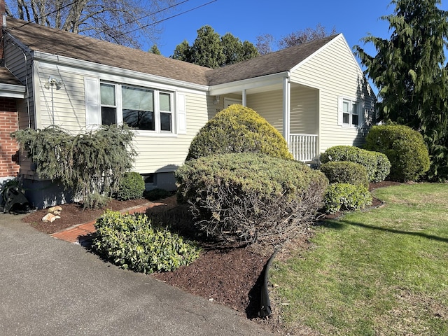 view of side of home featuring a lawn
