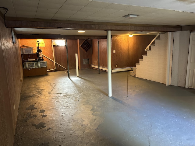 finished basement with wood walls and stairs
