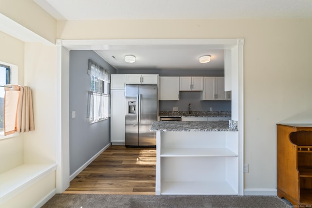 231 Heritage Vlg Unit C, Southbury, CT 06488 - kitchen with stainless steel fridge with ice dispenser, plenty of natural light, dark stone counters, and white cabinets
