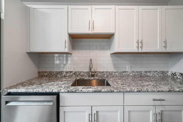 231 Heritage Vlg Unit C, Southbury, CT 06488 - kitchen with dishwasher, white cabinets, tasteful backsplash, and light stone countertops