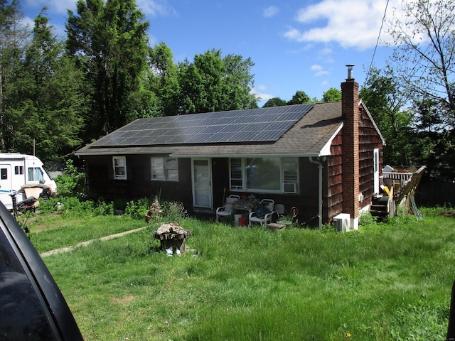 37 Foley Ave, Shelton, CT 06484 - view of front facade featuring a chimney, a shingled roof, and roof mounted solar panels