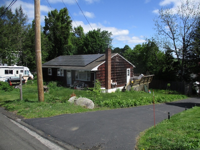 37 Foley Ave, Shelton, CT 06484 - view of front of house with solar panels, a chimney, and a front lawn