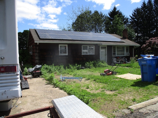 37 Foley Ave, Shelton, CT 06484 - view of front of property with solar panels, a chimney, roof with shingles, and a front yard